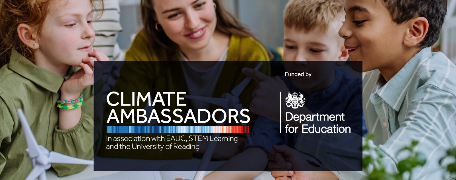 Children smiling at each other around a desk. A text box in the centre reads 'Climate Ambassadors. In association with EAUC, STEM Learning and the University of Reading. Funded by Department for Education."