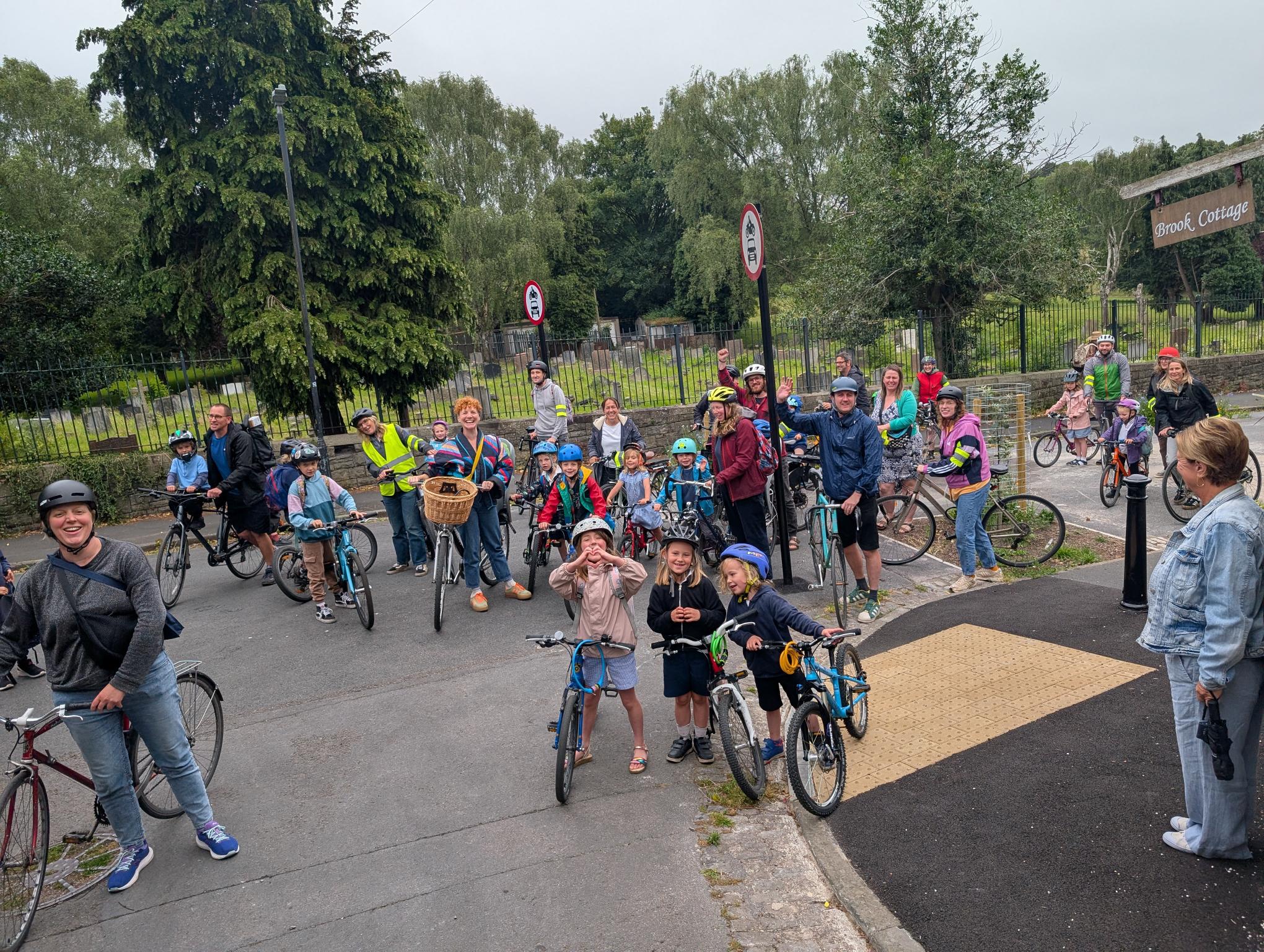 A group of children and adults on bikes.